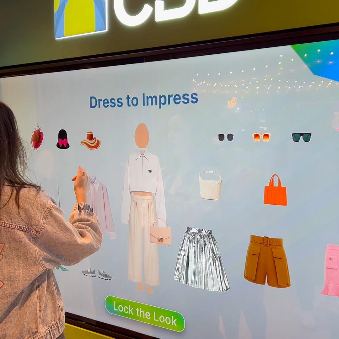 People playing a multi-level interactive financial literacy game at a brand activation event in Dubai, learning how to save and invest money.